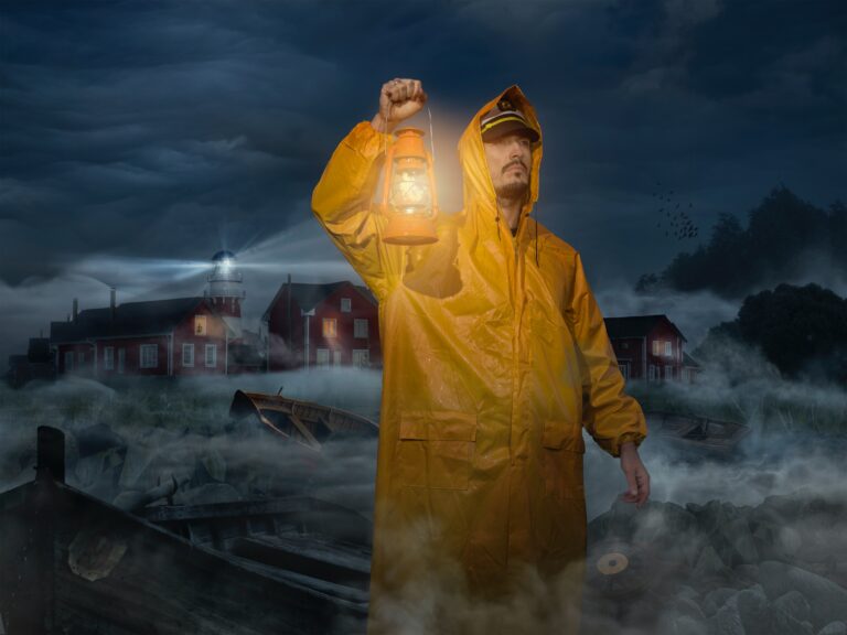 A sailor at night with a lamp and a yellow rain coat